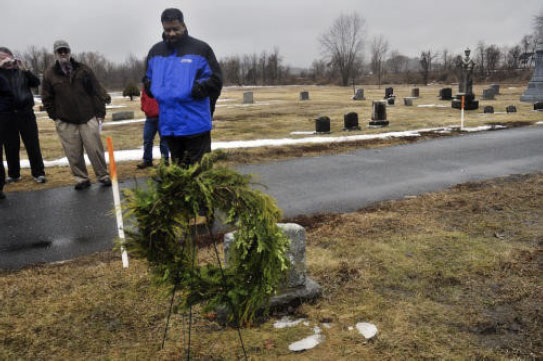 Arthur E. McFarlane II lays a wreath on the grave of his great-grandmother, Nina Gomer Du Bois, first wife of W.E.B. Du Bois, on Wednesday in Great Barrington. McFarlane’s first trip to the town was packed with activities and a ‘historic’ presentation at the Du Bois Center. (Caroline Bonnivier Snyder / Berkshire Eagle Staff)